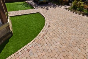 Driveway and artificial grass installed by Stow Construction & Landscaping in Lasswade Road, Edinburgh 2012 using Marshalls Tegula Drivesett, Traditional and Drivesett Deco, Cinder and Namgrass Oasis.