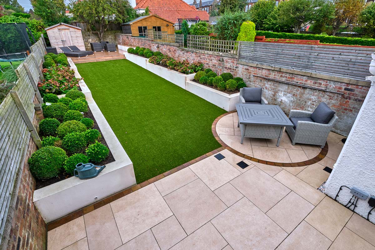 Patio, walling, steps, artificial grass and landscaping designed and installed by Stow Construction & Landscaping, Marshalls Always Green, Summer Lawn, Symphony Vitrified, buff, Drivesett Savannah, Autumn, topsoil, limited access, landscaping, paving, designer, installer, Edinburgh